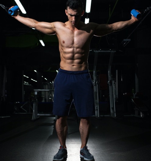 Athlete lifting dumbbells as part of a strength training program